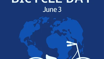 Weißes Fahrrad vor stilisierter Weltkarte auf blauem Hintergrund mit Text WORLD BICYCLE DAY June 3